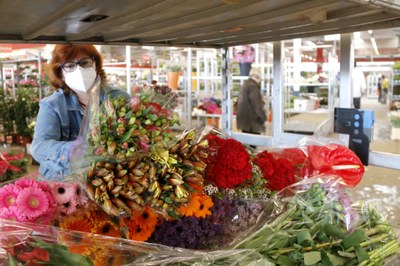 Una florista amb mascareta comprant flors al Mercat de Flor i Planta Ornamental, el 29 d'abril de 2020 