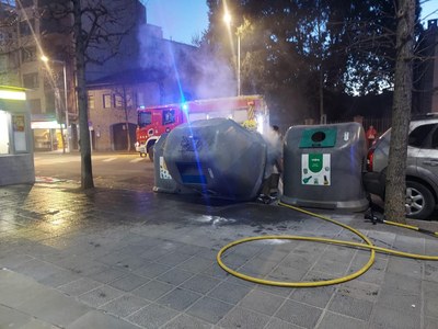 Els Bombers apaguen un incendi en un contenidor de paper al costat de la plaça de les Monges de la Seu