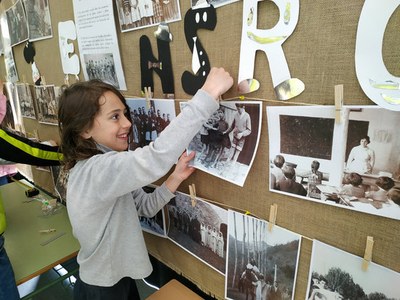 Una alumna penja una de les fotografies (Foto: Escola La Plana de Montrós)